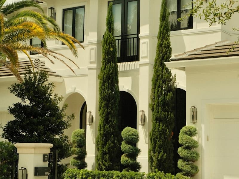 Upscale Florida home with palms and topiary